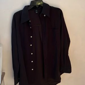 A super cute black corduroy light blouse. Never worn. Very trendy size medium.